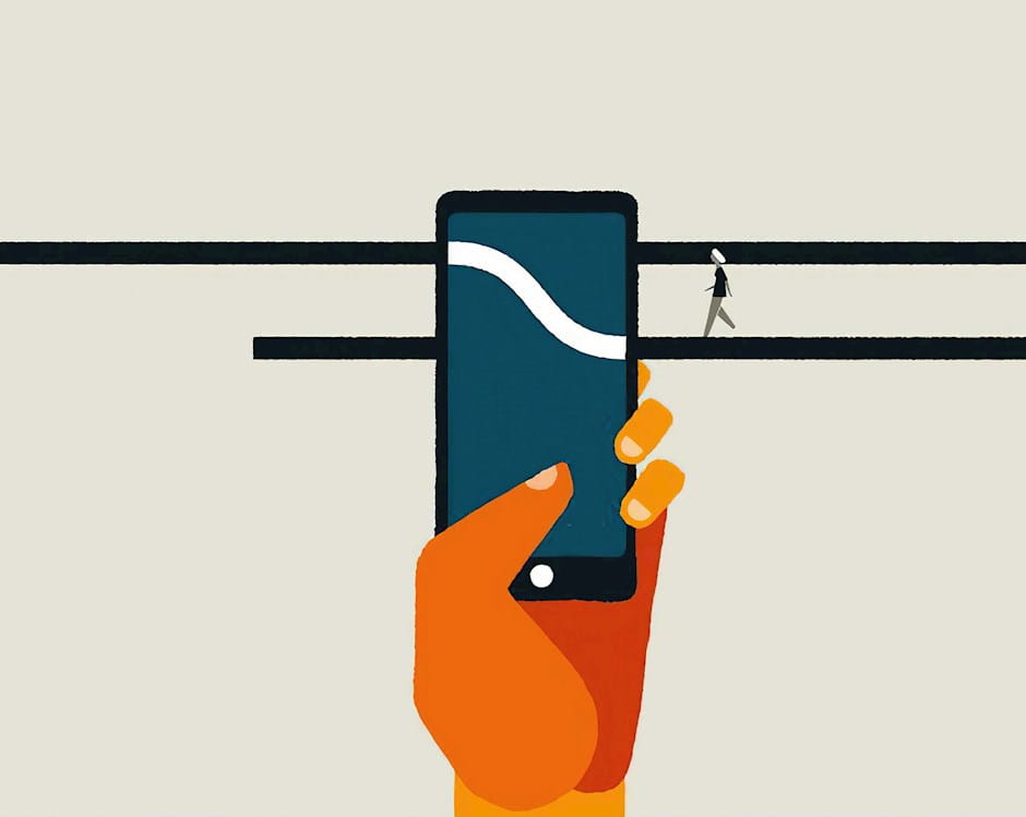 Hand holding a cell phone in front of small ledges with people walking