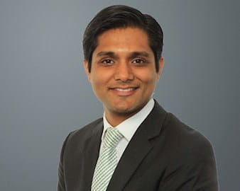 Black and white headshot of Vidur Gupta in front of a gray background 