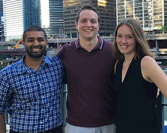 Evening-Weekend students Ashray Reddy, Connor Blankenship, and Rebekah Krikke stand and smile along the Chicago River in downtown Chicago.